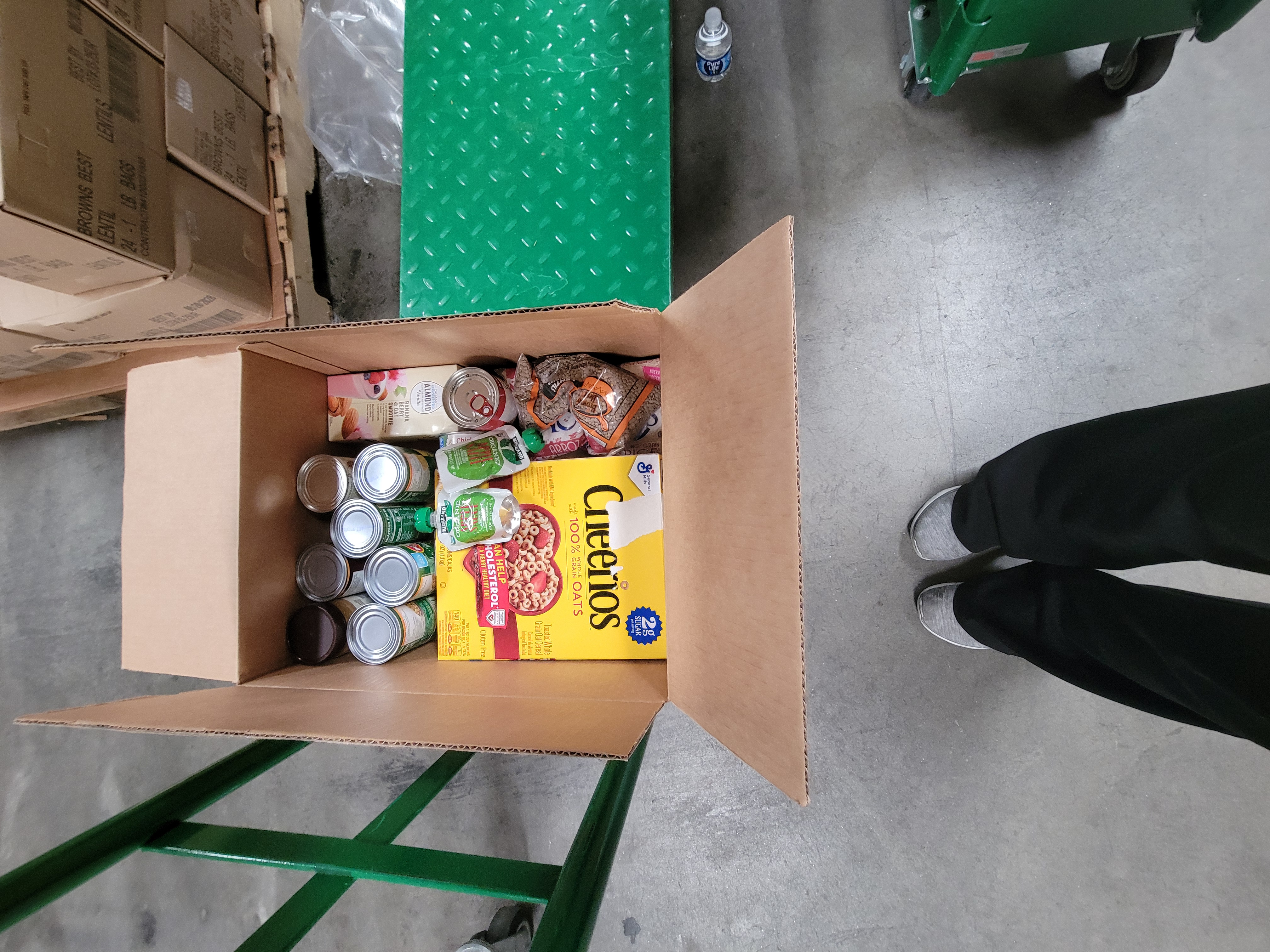 Cardboard box of dry goods on a cart.